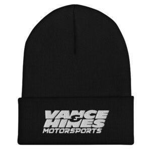 Close-up of a black knit beanie with white embroidered text reading 'Motorsports' on the front.